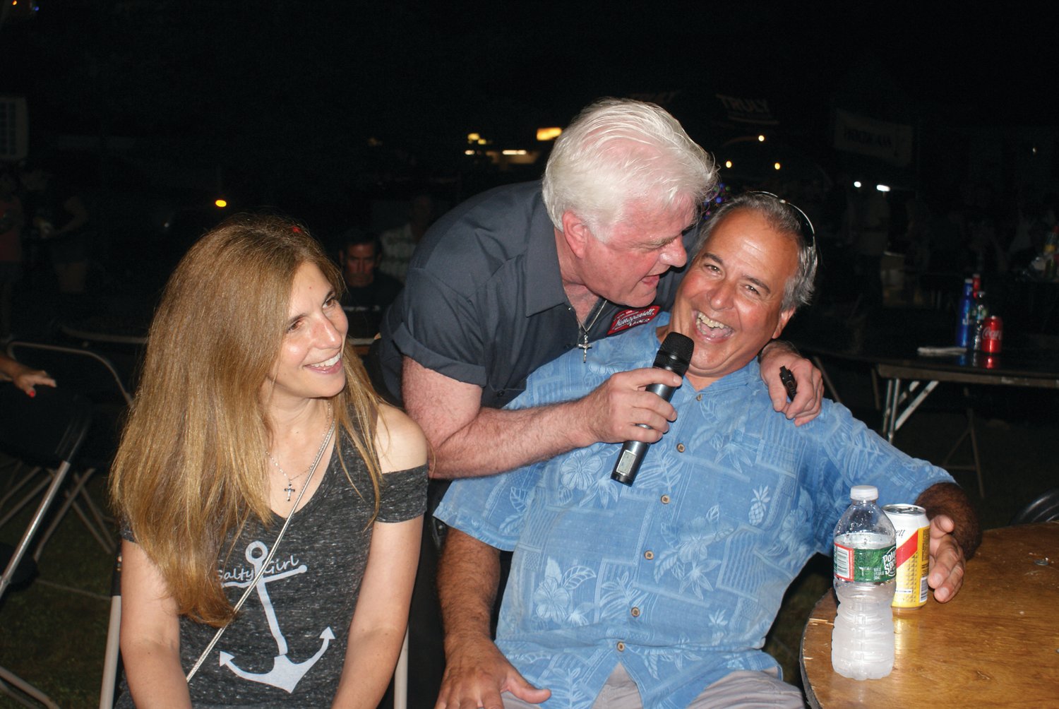 FUN WITH THE CROWD: Steve Smith from the band Steve Smith and the Nakeds, which performed Friday night at the St. Mary’s Feast, had some fun with audience member Stan Colasante and his friend Marisa Castello. 